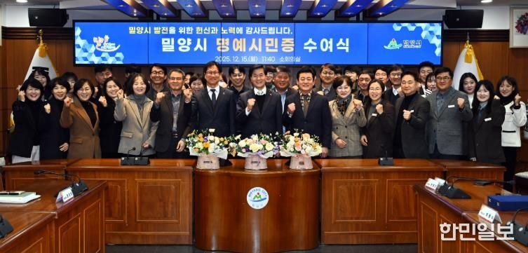 2: 15일 밀양시청 소회의실에서 열린 명예시민증 수여식 참석자들이 함께 기념 촬영을 하고 있다.