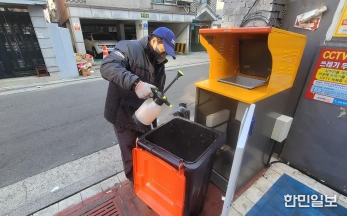 강북구 전문인력이 RFID 종량기를 세척, 소독하고 있다.