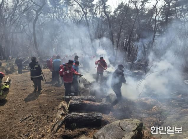 지난 12일 팔달산 화재 현장에서 잔불을 정리하는 모습